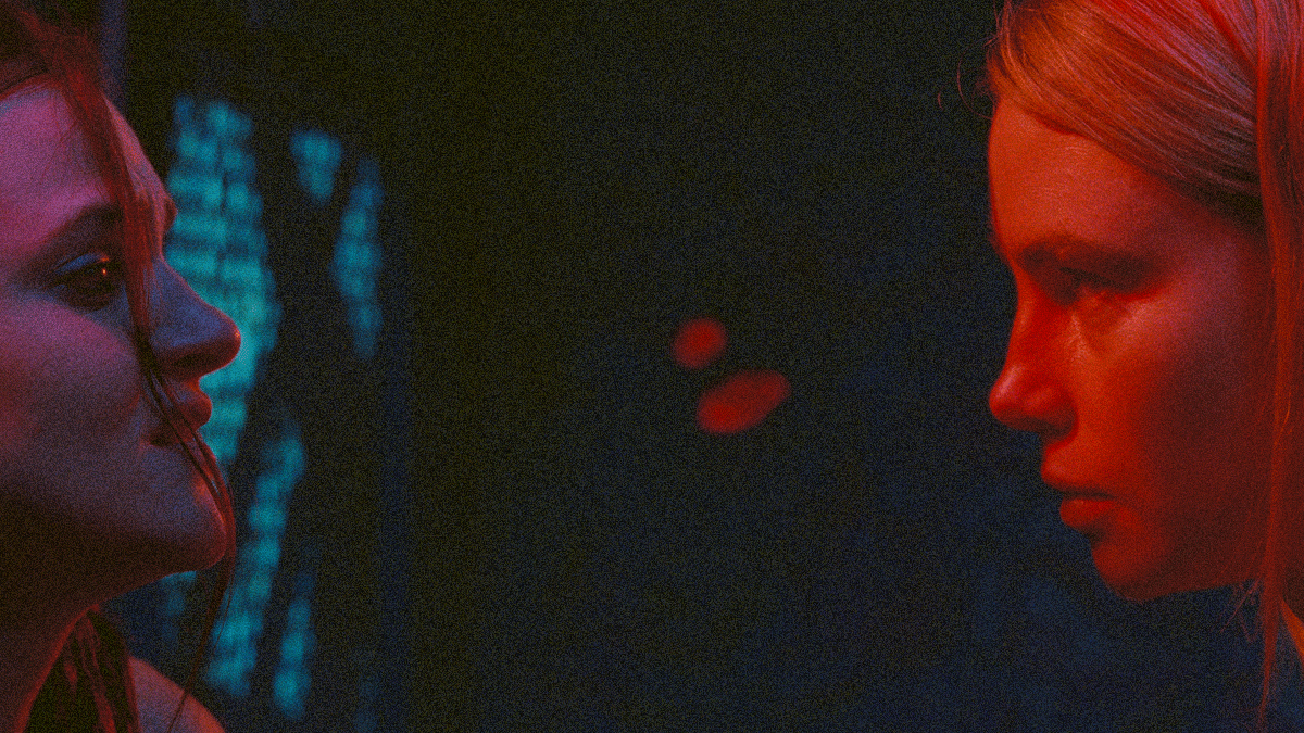 Madeline Brewer cropped off the left and Lucy Fry cropped off the right, both looking at the other.