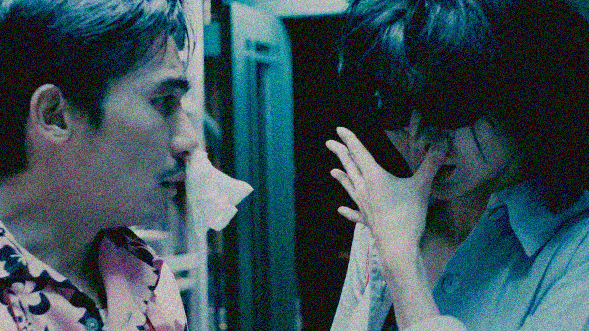 Close-up of the bloodied duo of Tony Leung (with tissue hanging from nose) and Maggie Cheung (holding thumb to nose).