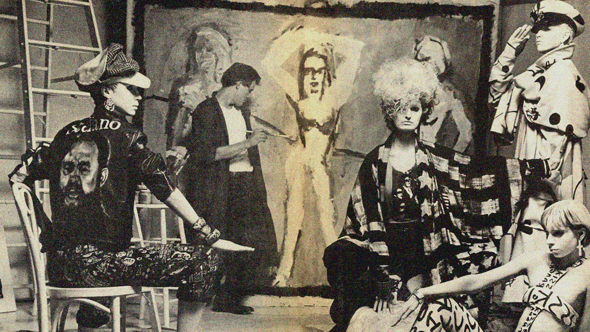 An image from MAKE ME FAMOUS with Edward Brezinski painting in background on large canvas and models in foreground.