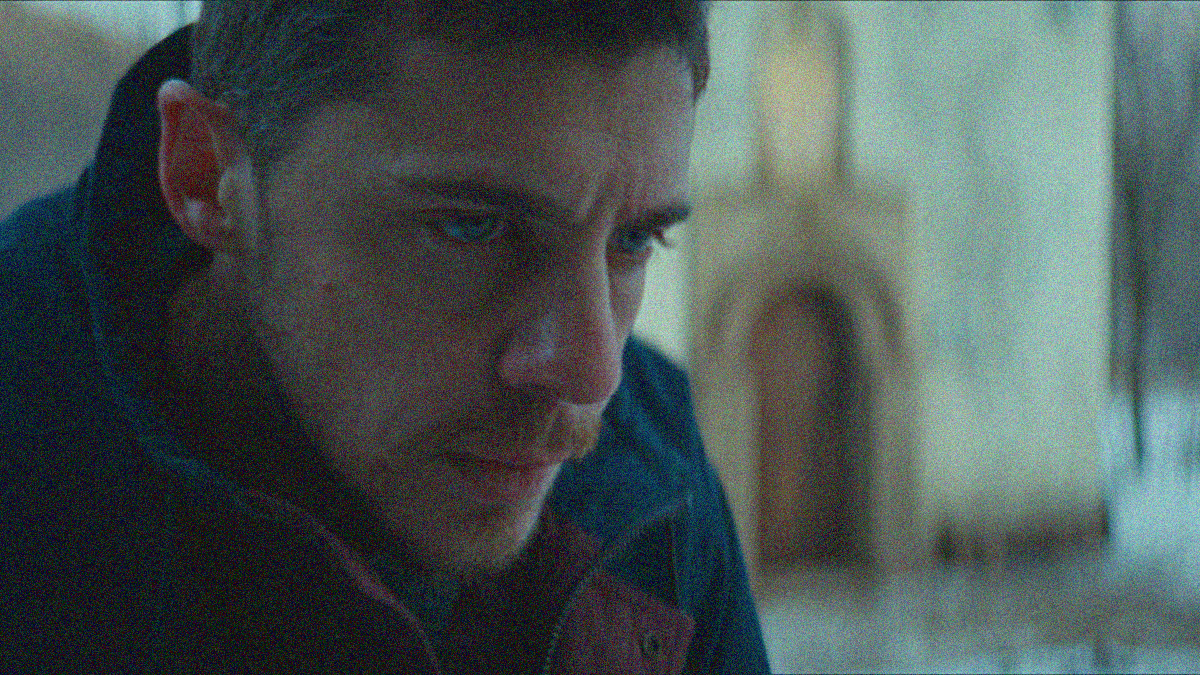 Close-up on a man's stern face.