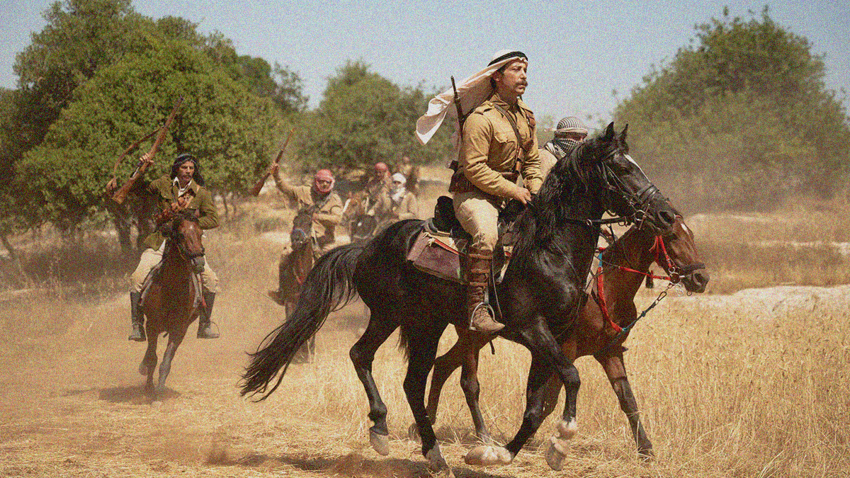 A band of rebel Palestinians ride through the frame on horseback with trees behind them.