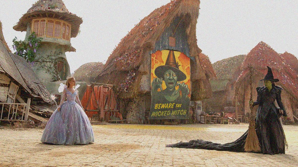 A long lens view of an empty town marred by a giant poster of a green witch that reads "Beware the Wicked Witch" sits behind two women staring at each other. The one on the left wears a pink gown and holds a crystal wand. The one on the right wears a black dress with long train and holds a broomstick.